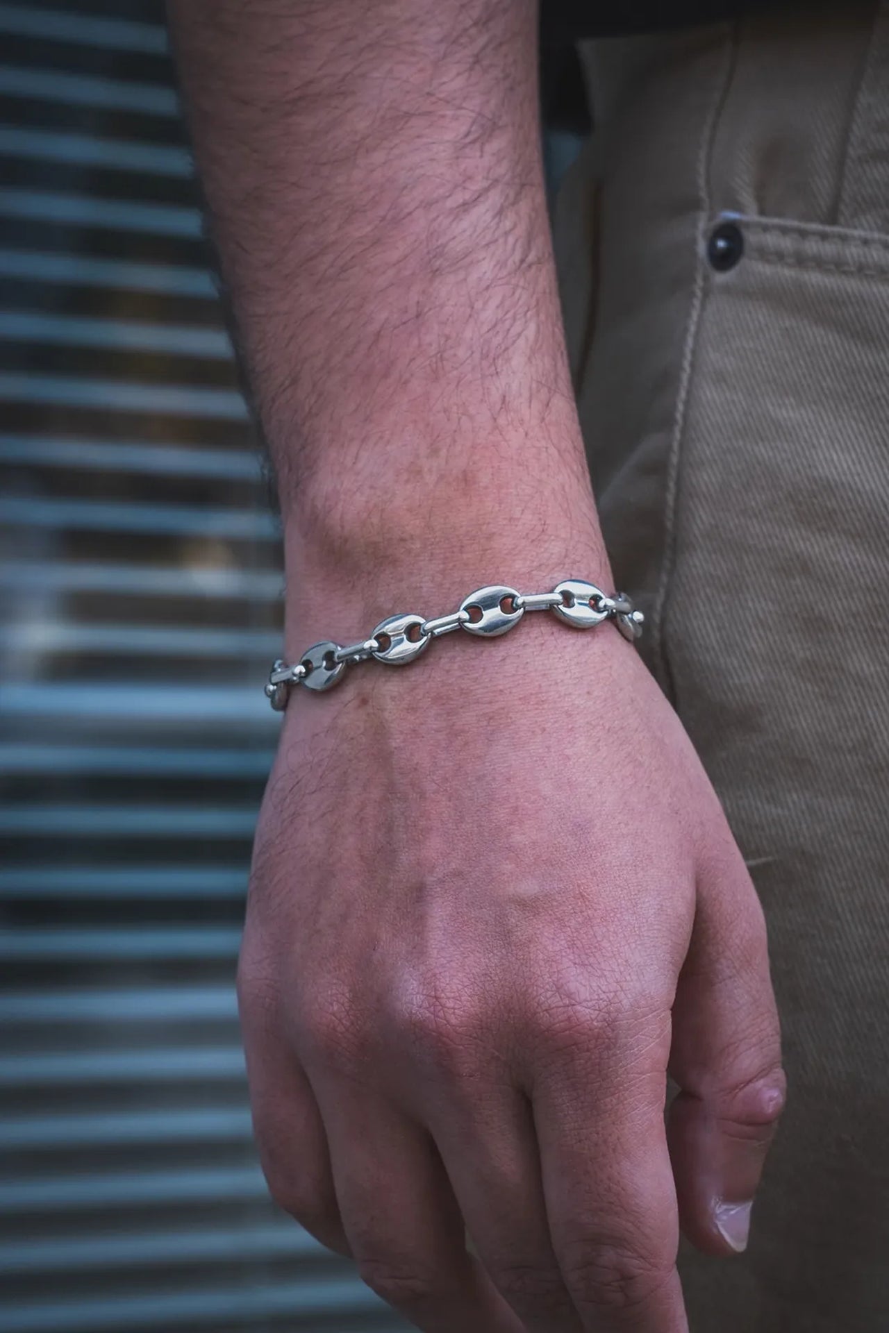 Gümüş renkli metal bileklik, erkek kolunda oval zincir detaylı
