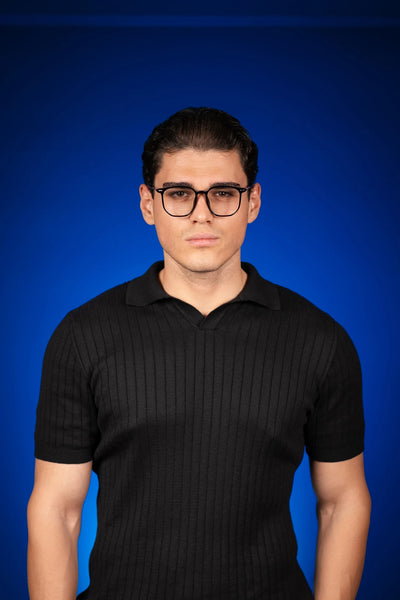 Siyah ribbed polo yaka tişört, mavi arka plan üzerinde erkek model
