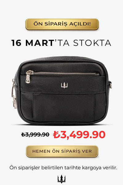 Siyah deri omuz çantası, ön cebi ve fermuarlı kapak detayıyla